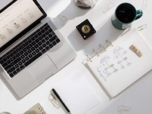 Lucid_Origin_Topdown_desk_stilllife_open_laptop_showing_a_mini_0.jpg